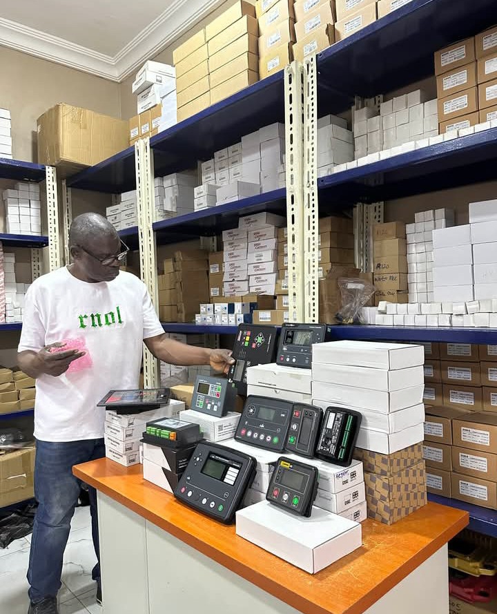 Sylvom Nigeria Limited staff with generator control modules in the Lagos parts warehouse